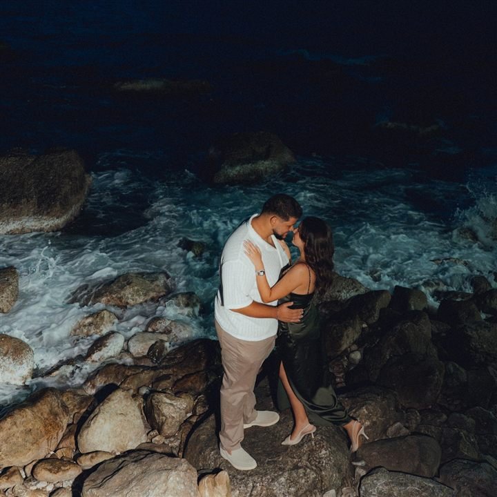 Fethiye elopement photographer — couple on coastal rocks at night